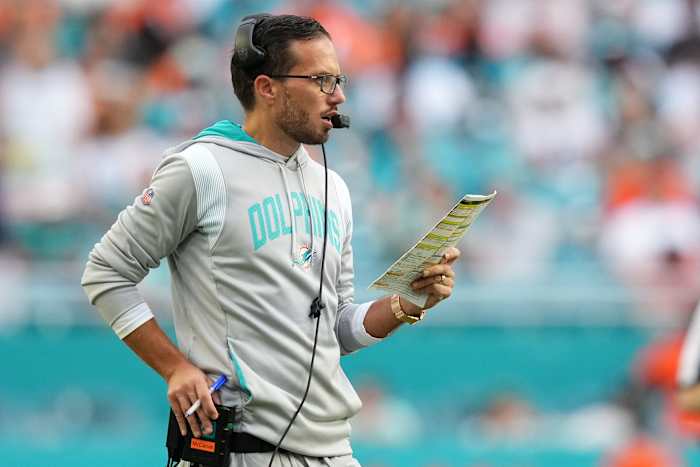 Dolphins coach Mike McDaniel looks over his play sheet during a game.